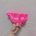 Pink silicone whale holder mold held to show its cavity