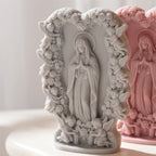 Close view of praying figure, roses and cherub border