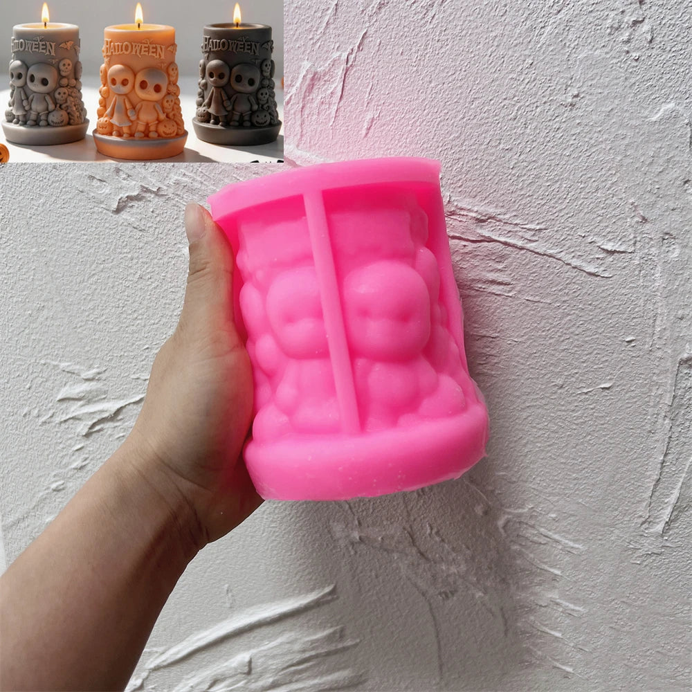 Pink Halloween skull-scene pillar silicone mold held in one hand