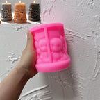 Pink Halloween skull-scene pillar silicone mold held in one hand