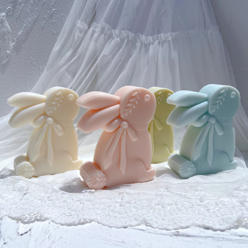 Three upright rabbit castings with swept-back ears and neck bows