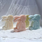 Three upright rabbit castings with swept-back ears and neck bows