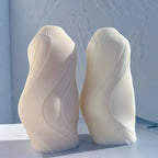 Two fine-ribbed flowing wave candle castings