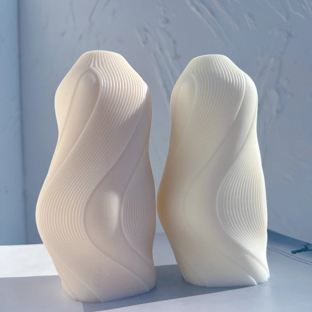 Two fine-ribbed flowing wave candle castings
