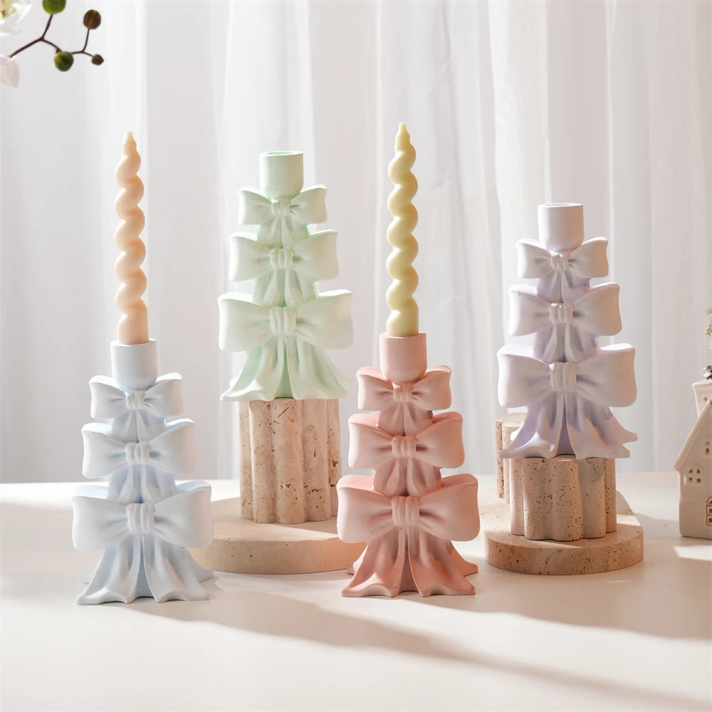 Three-tier bow holders in pastel colors with top candle sockets