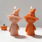 Close-up of cream and orange witch figures