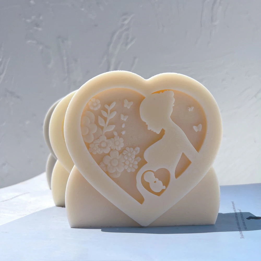 Heart reliefs with pregnancy silhouettes and floral details