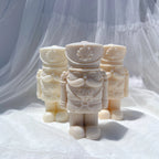 Three cream stout nutcrackers with patterned uniforms