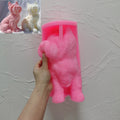 Pink silicone Yorkshire terrier mold held in one hand