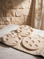 Three decorative six-well plate castings on patterned fabric