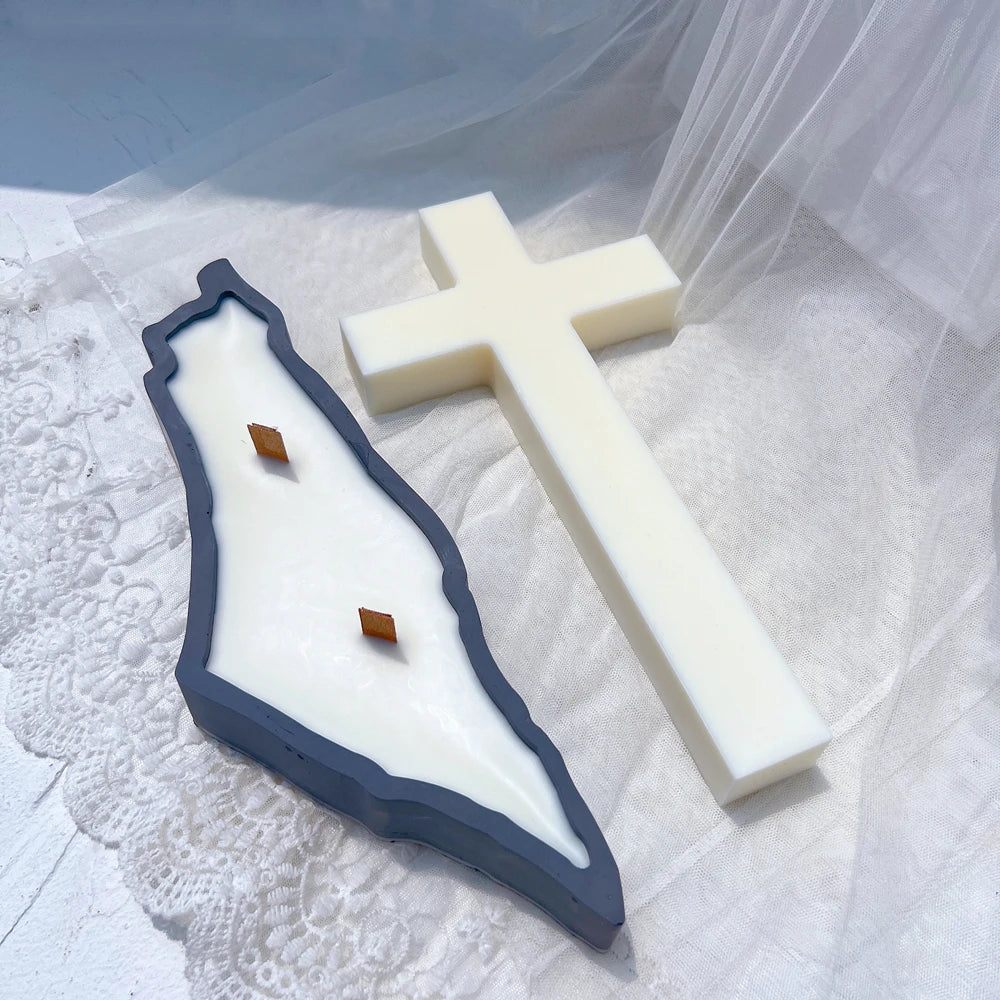 Irregular map-outline decorative casting beside a plain cross
