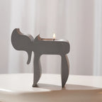 Single gray Chai candle holder with open frame and sculpted silhouette