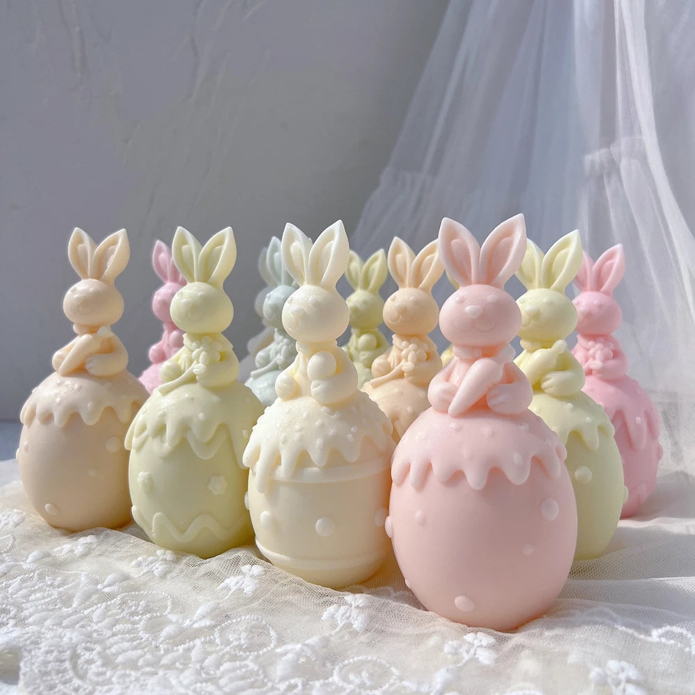 Rabbit and decorated egg castings grouped on a lace-covered surface
