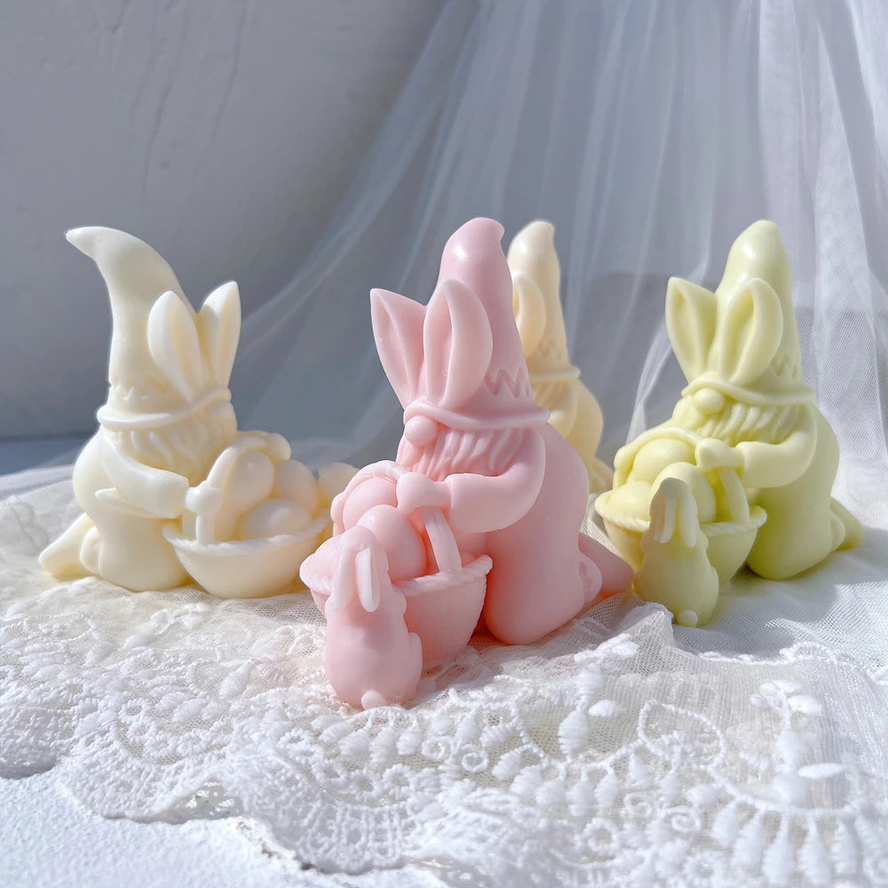 Easter gnome candles with bunny-ear hats baskets and small rabbits