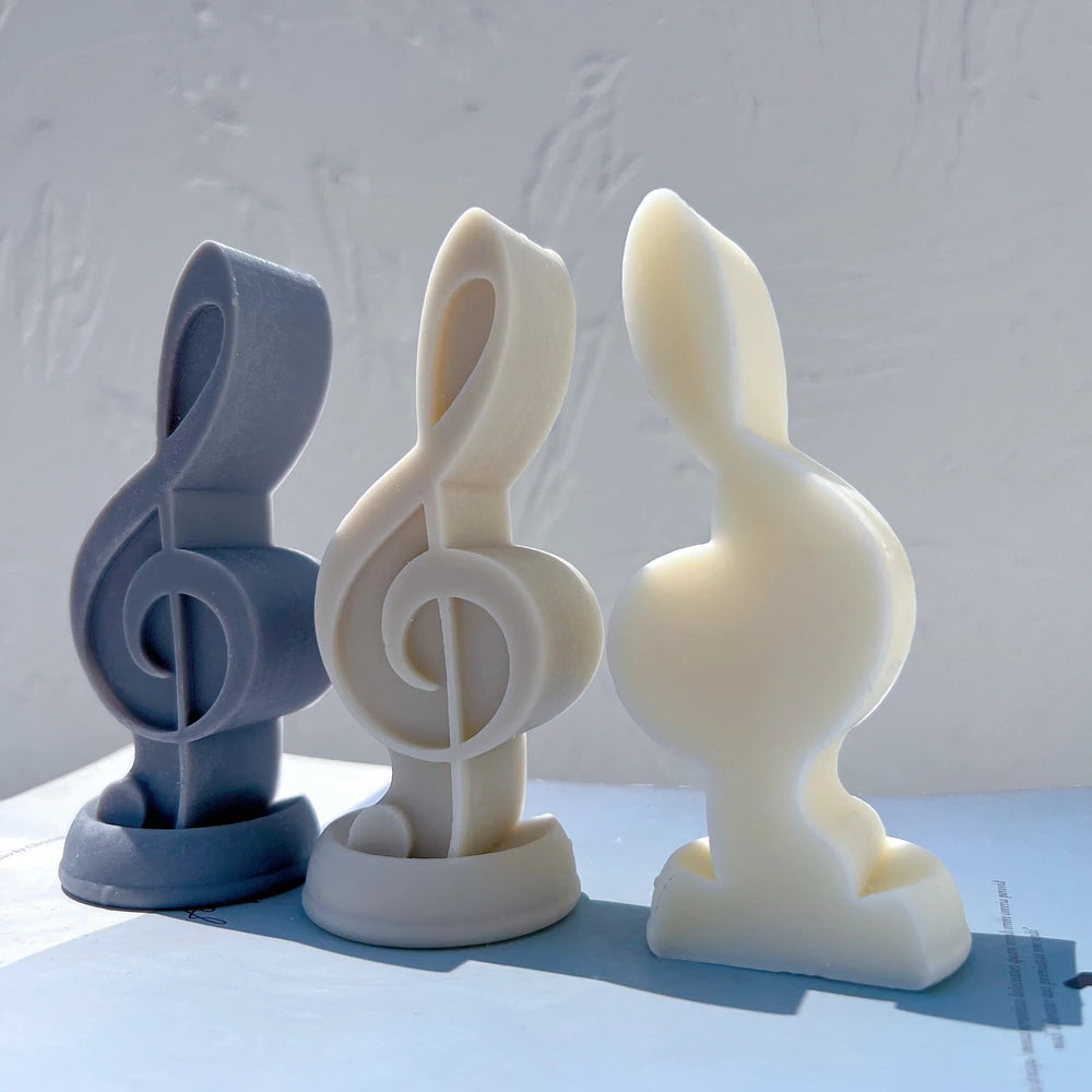 Smooth rear of cream treble clef beside two front-facing figures
