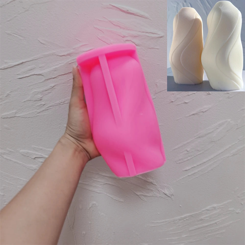 Pink fine-ribbed wave silicone mold held in one hand