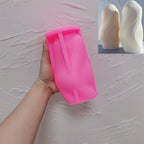 Pink fine-ribbed wave silicone mold held in one hand