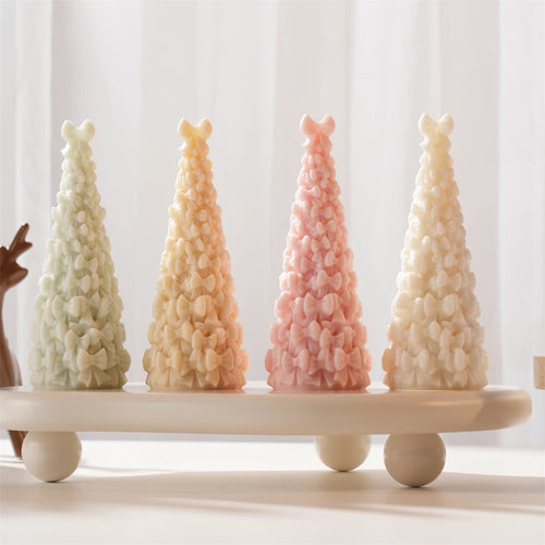 Front view of pastel conical trees with allover ribbon bows