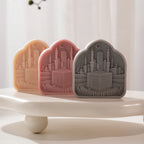 Arched Kaaba relief castings with crescent and skyline backdrop