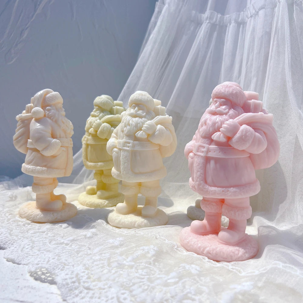 Standing Santa figurines in different wax colors with sack, coat and textured base