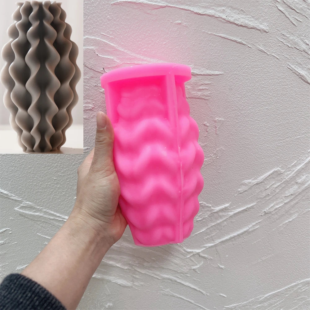 Pink wavy-ridge silicone mold with a matching gray casting inset