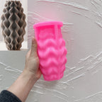 Pink wavy-ridge silicone mold with a matching gray casting inset