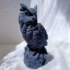 Dark owl casting showing rounded eyes and pointed ear tufts