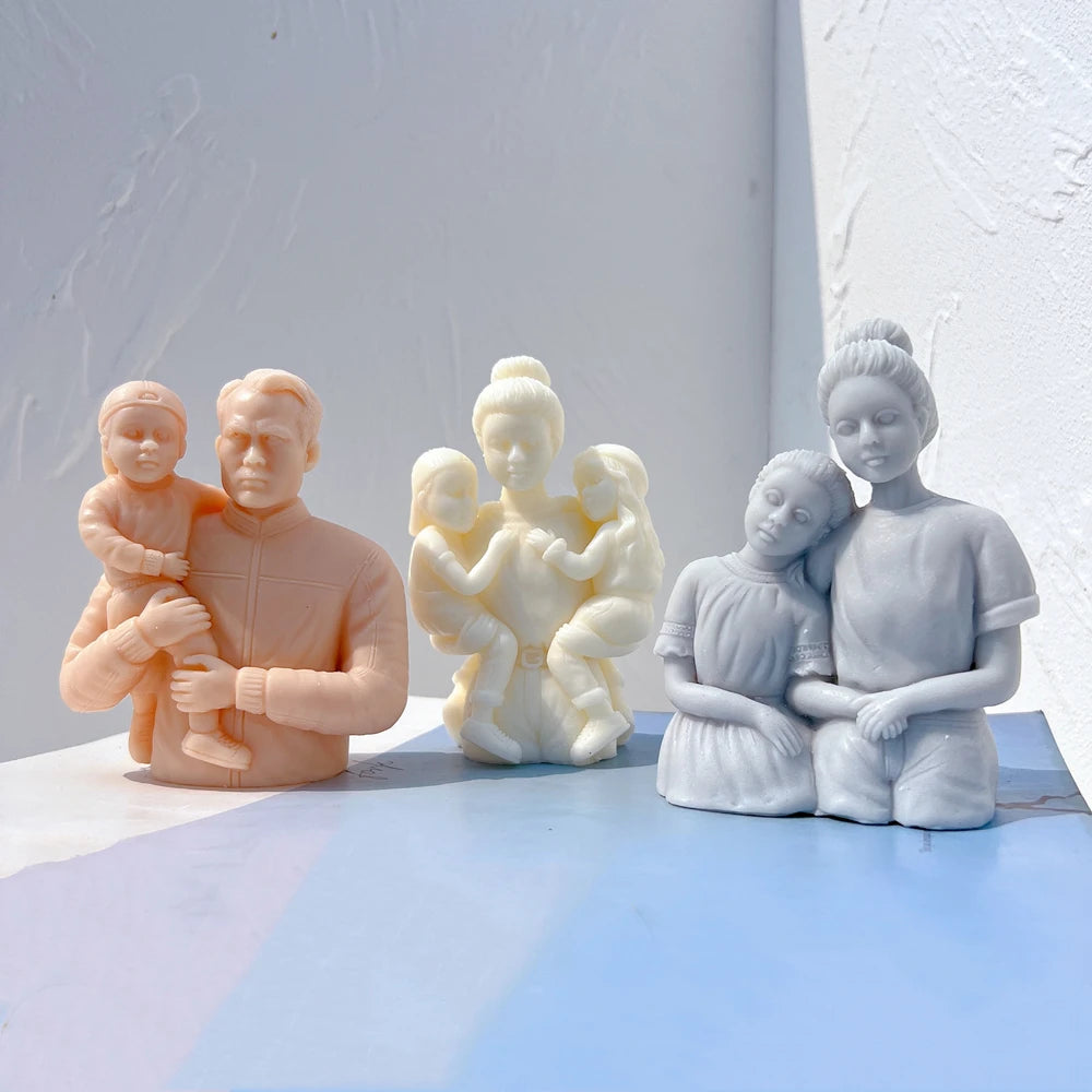 Three parent-and-child sculpture designs in pastel wax