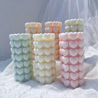 Pastel heart pillar candles showing the raised repeating pattern