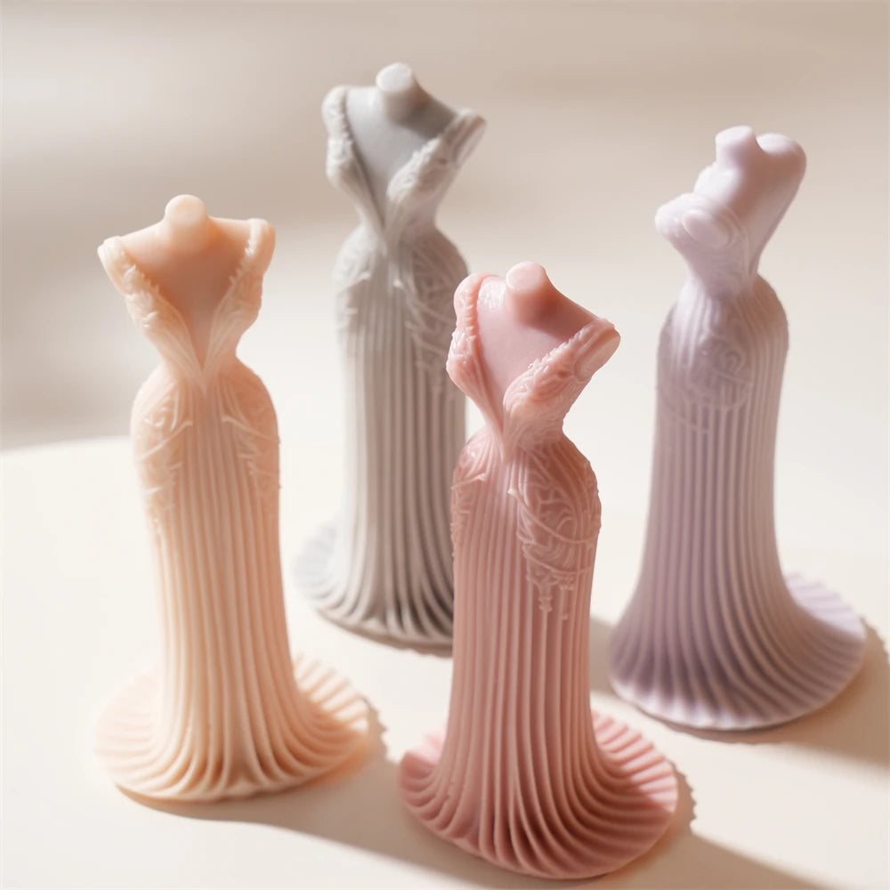 Four fitted gown castings showing detailed bodices and long pleats