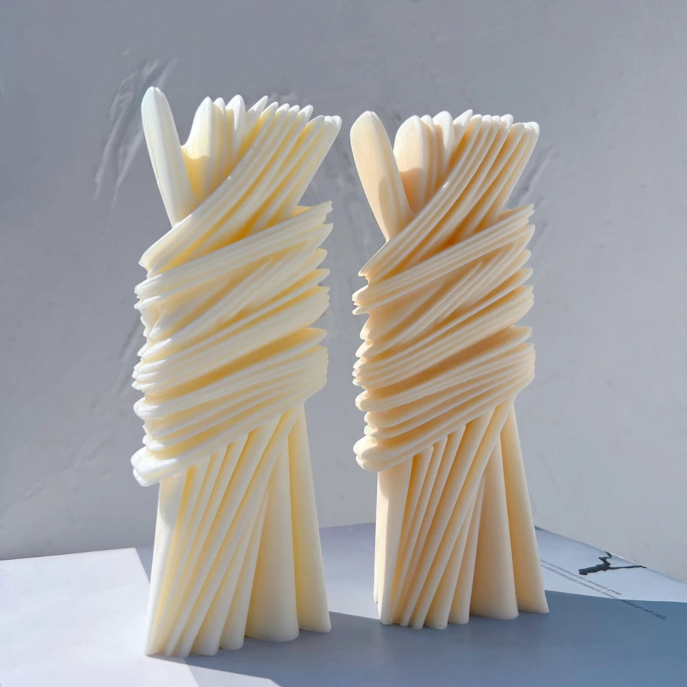 Front view of sculptural pillars with layered ribbon-like relief