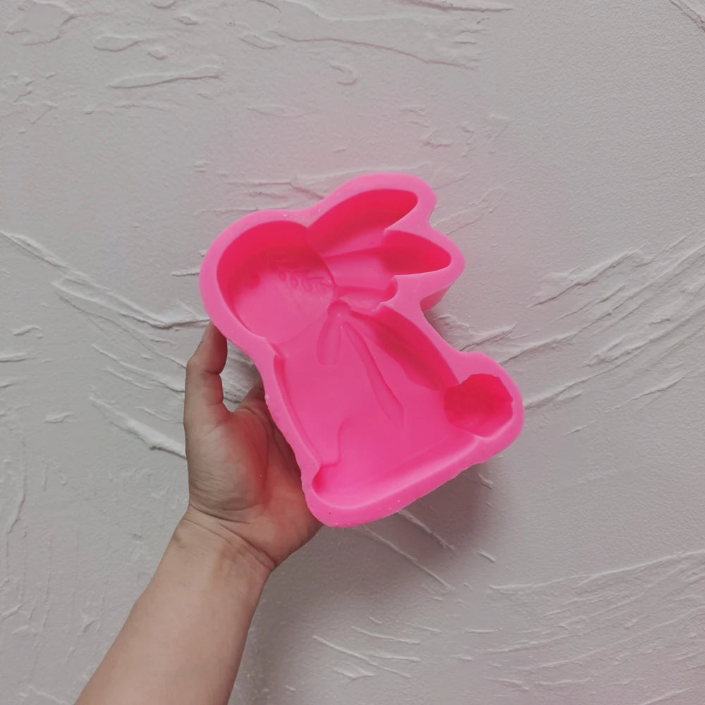 Pink leaf-detail rabbit silicone mold held in one hand