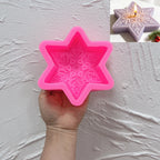 Pink silicone mold with six-point star outline and floral snowflake cavity