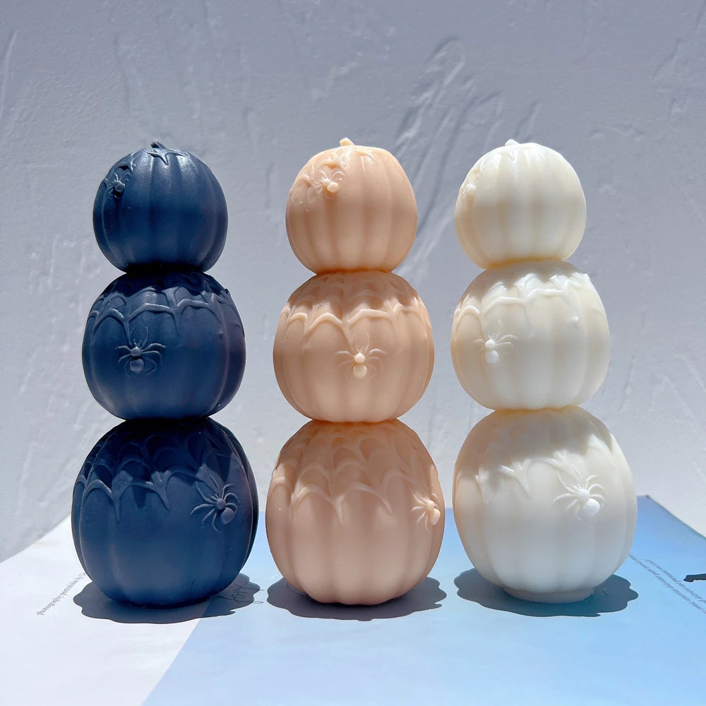 Three pumpkin towers in navy peach and cream with spiderweb relief