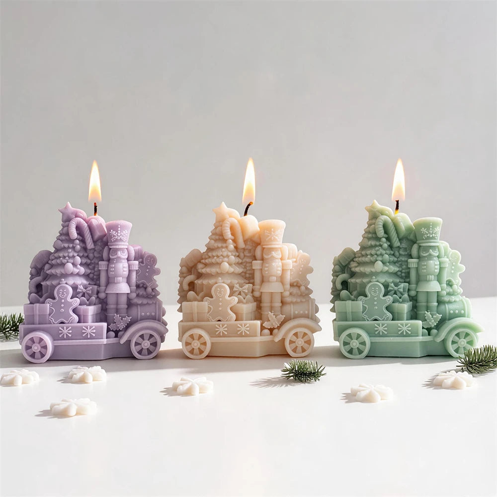 Three festive train candles showing wheels and snowflake side trim