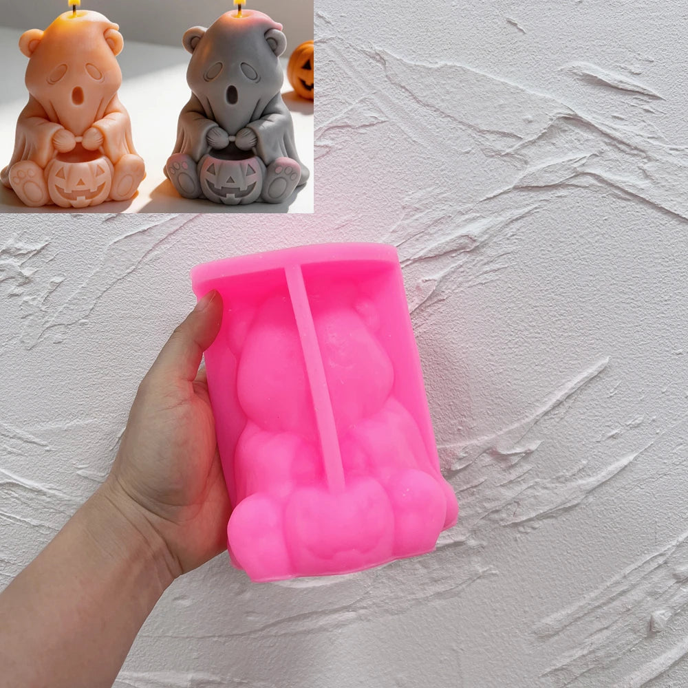 Pink silicone ghost bear and pumpkin mold held in a hand
