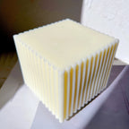 Smooth top and ribbed sides of a square candle