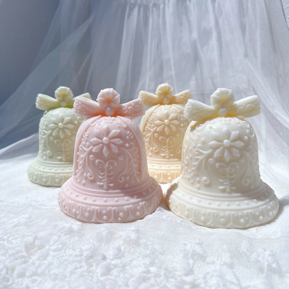 Festive bell castings showing raised bows and rounded bodies