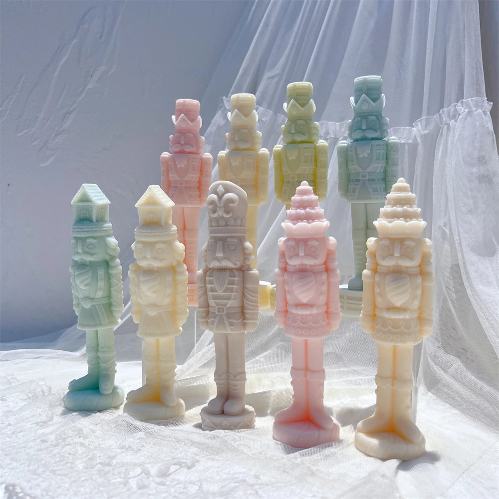 Group of pastel nutcracker figures on oval and circular standing bases