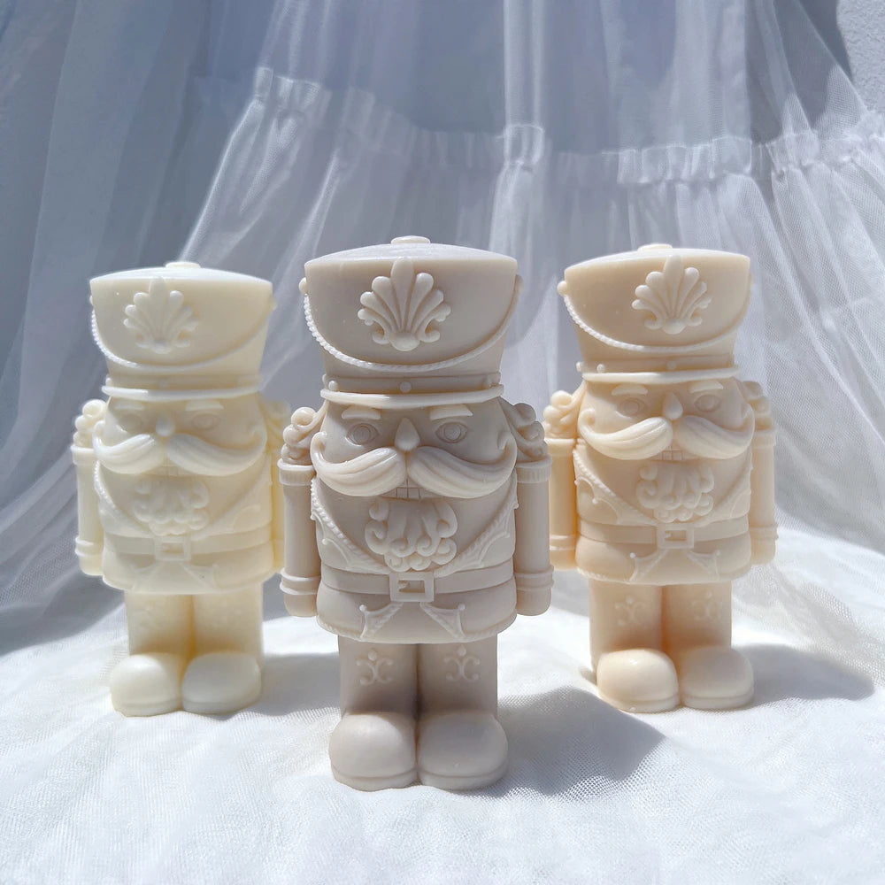Three stout nutcracker soldier castings with broad hats and rounded boots