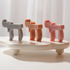 Three sculptural Hebrew Chai candles on a white display tray