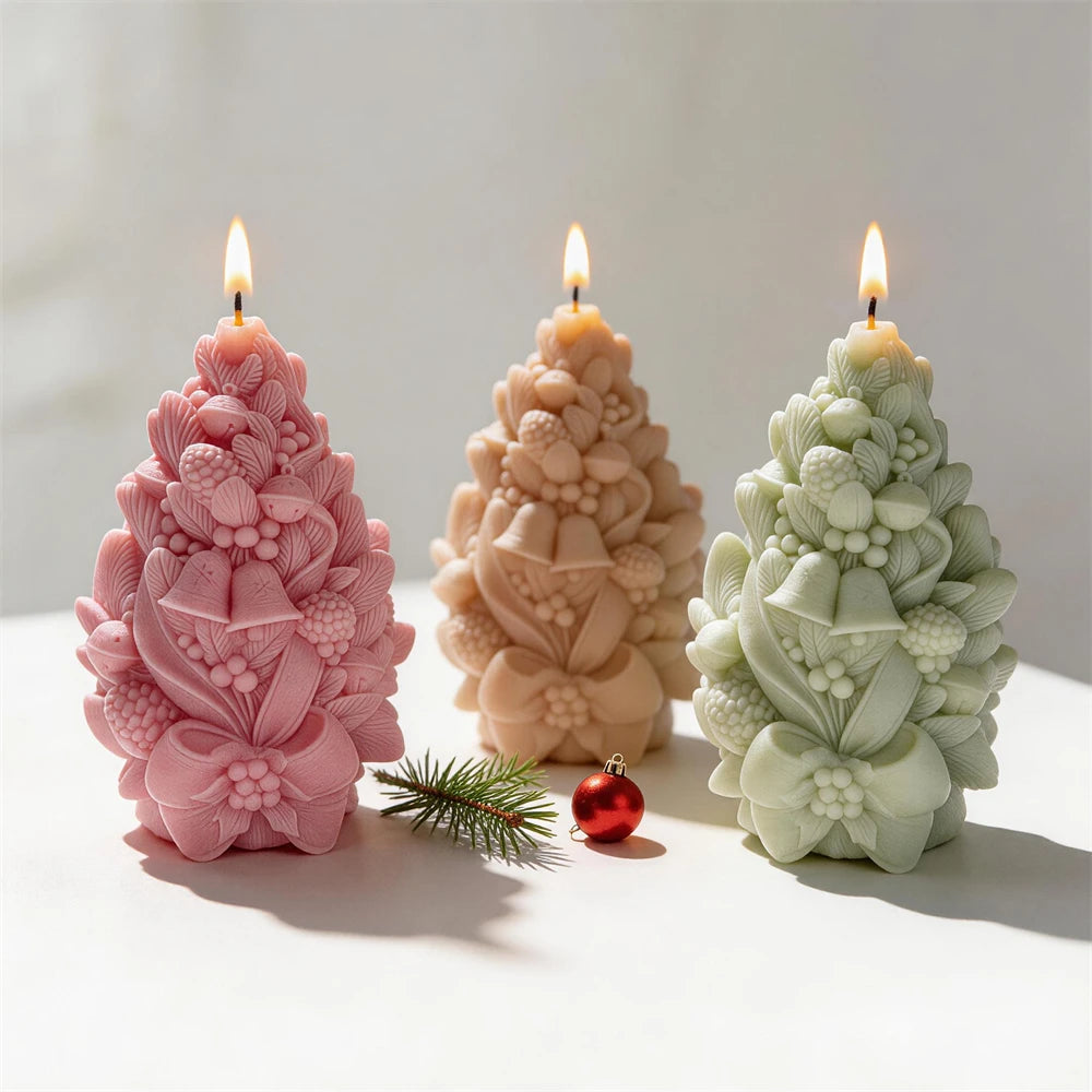 Three pinecone candle castings with bell and bow details