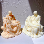 Two Pietà-style castings showing the reclining figure and folded robes
