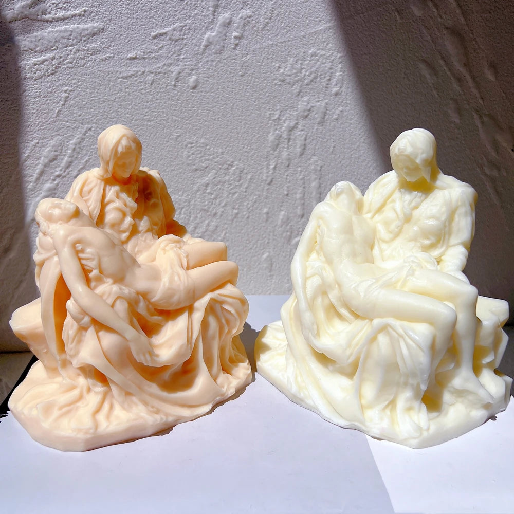 Two Pietà-style castings showing the reclining figure and folded robes