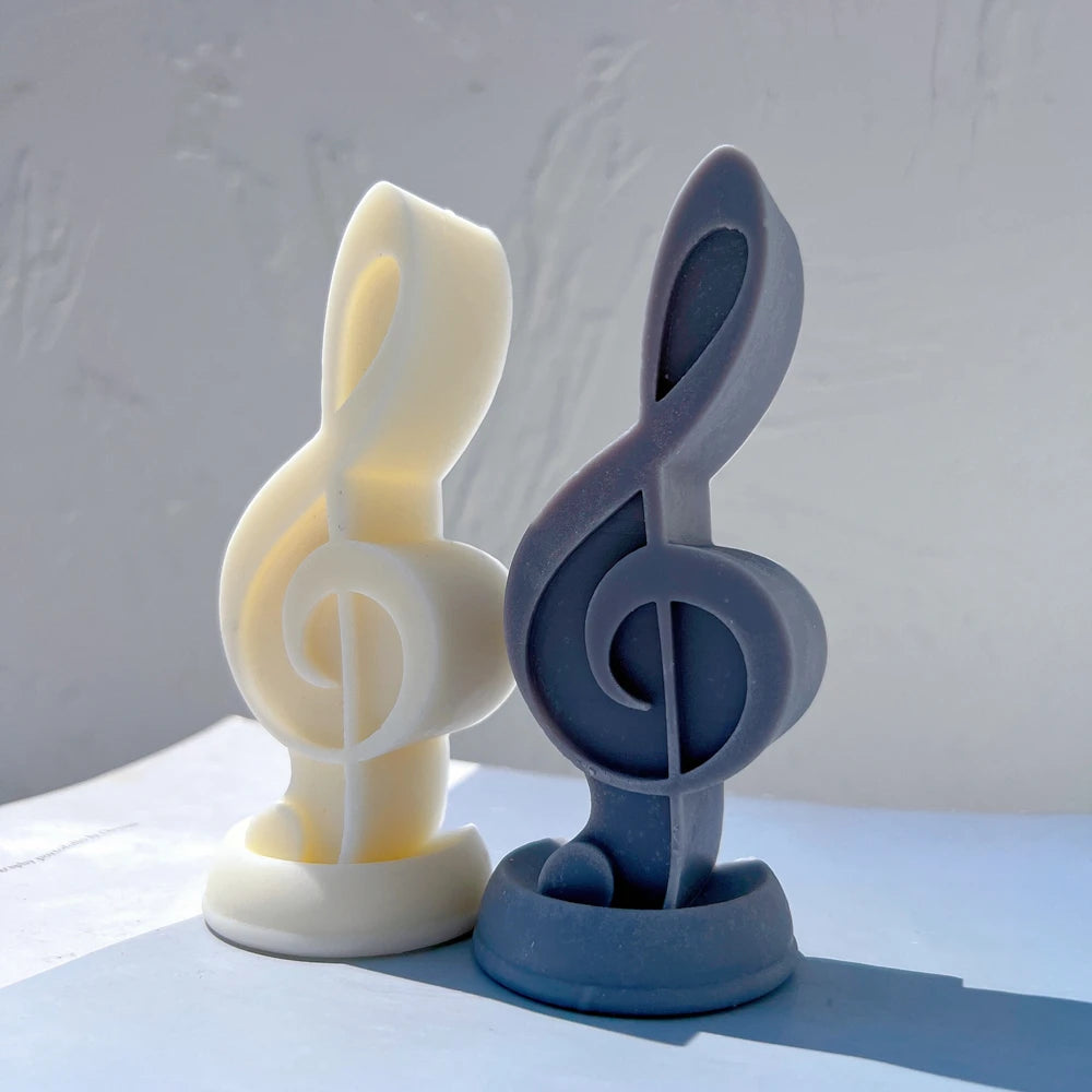 Yellow and blue treble clef castings showing their curved relief