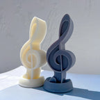 Yellow and blue treble clef castings showing their curved relief