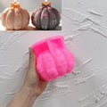 Pink silicone pumpkin mold with bow details in its cavity