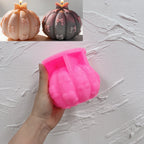Pink silicone pumpkin mold with bow details in its cavity
