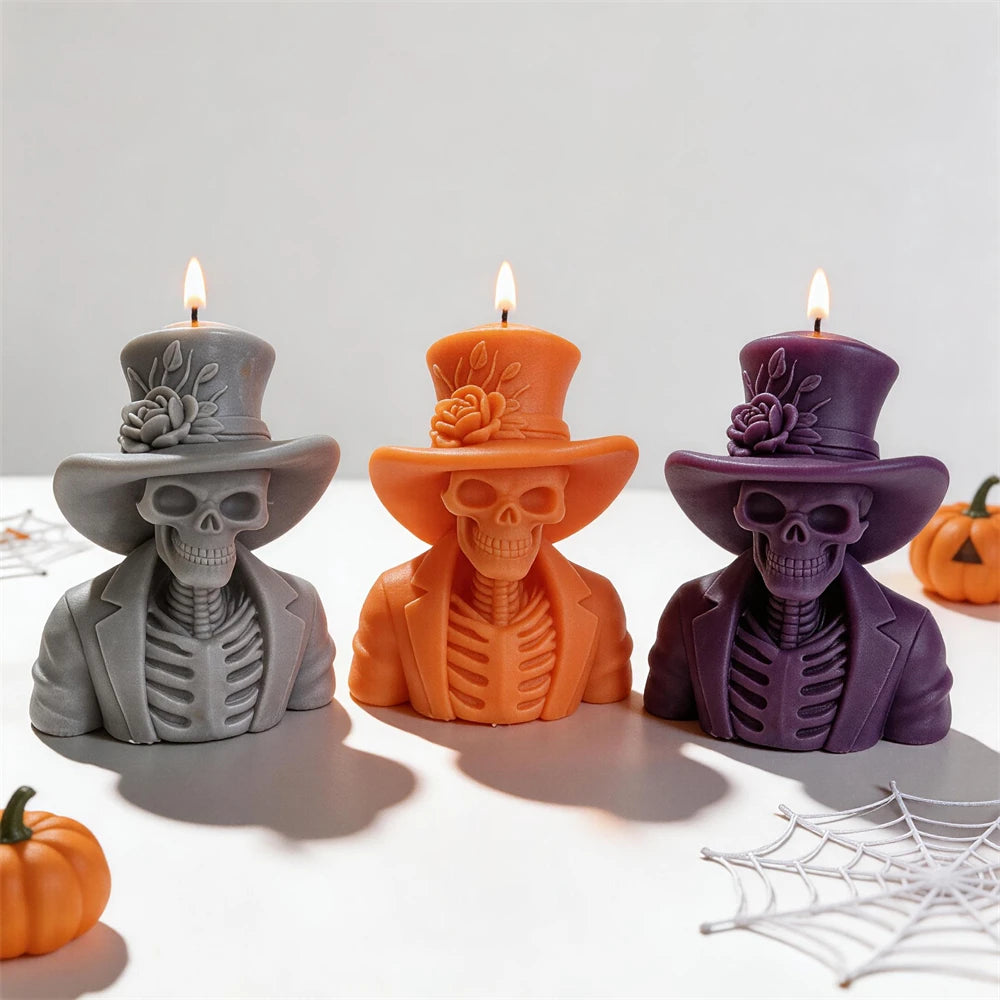 Scheletri a candela in grigio, arancio e viola con cilindri ornati di rose