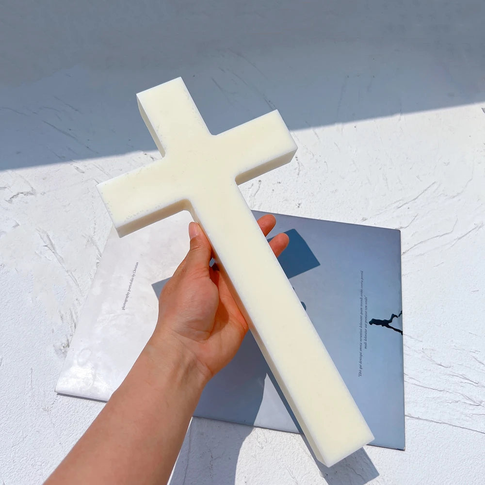 Plain cross casting held to show its long vertical stem